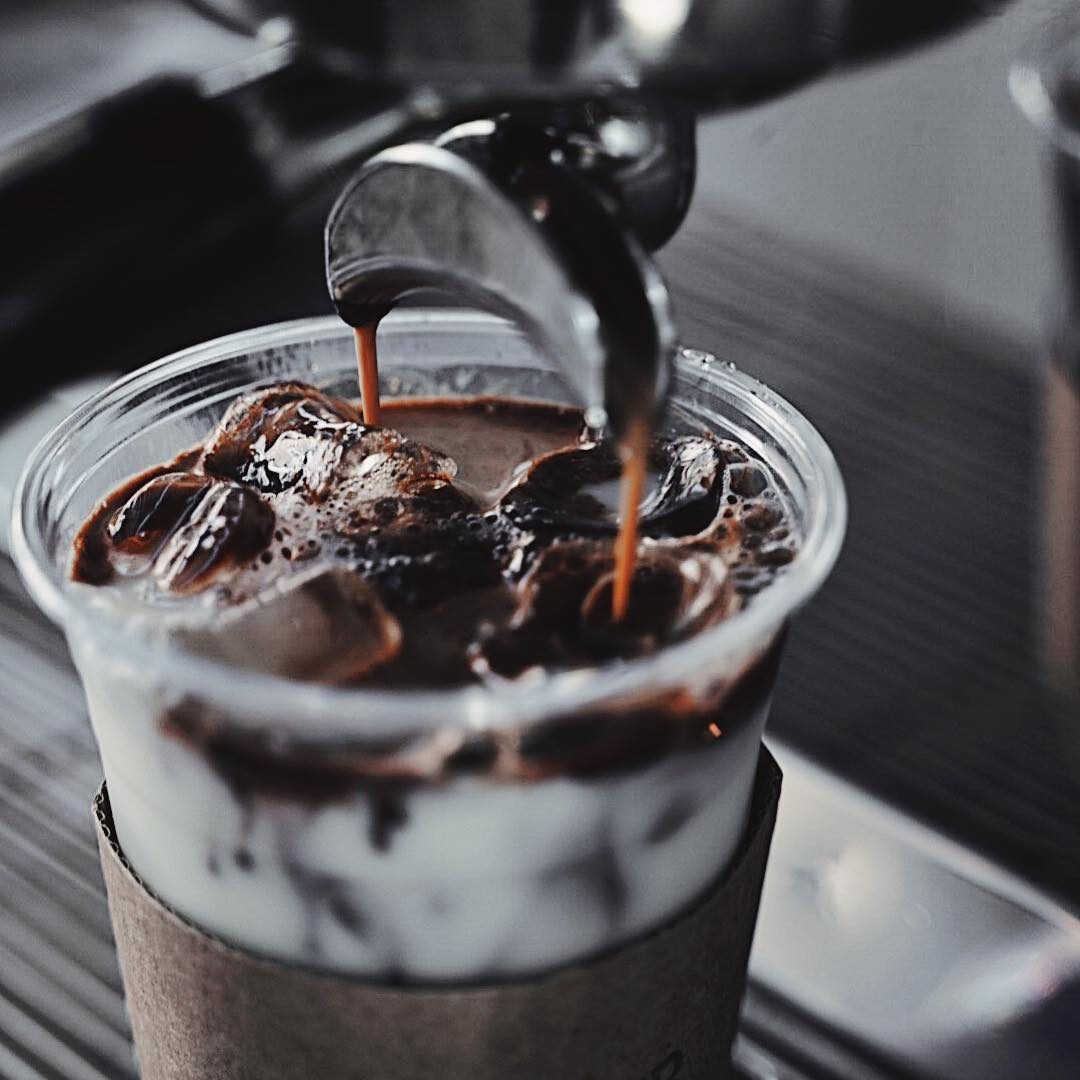 Espresso pouring over ice