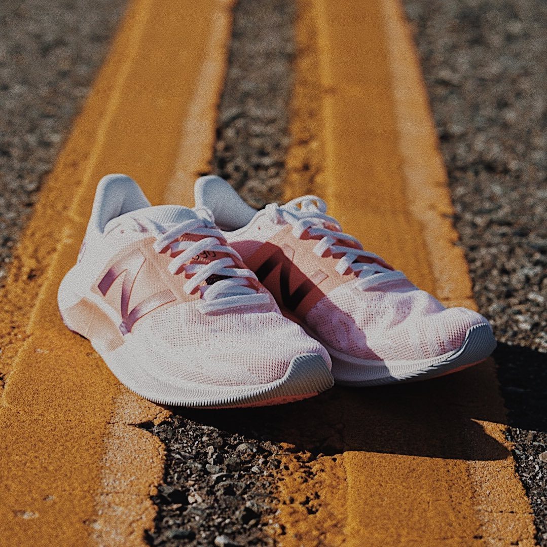 Pink New Balance sneakers on the road